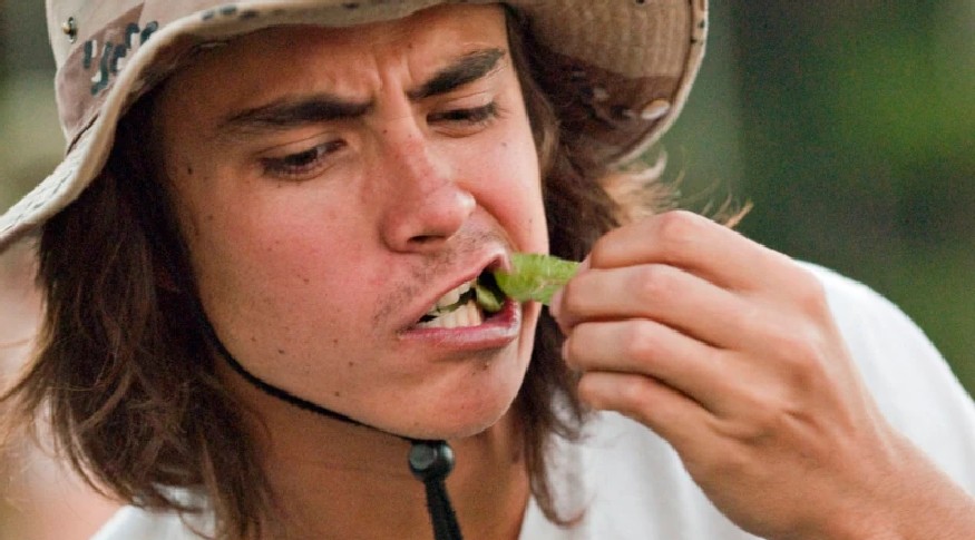 Tourist walking slowly and chewing coca leaves while following our blog. Coca leaf tea to prevent altitude sickness in Cusco. 